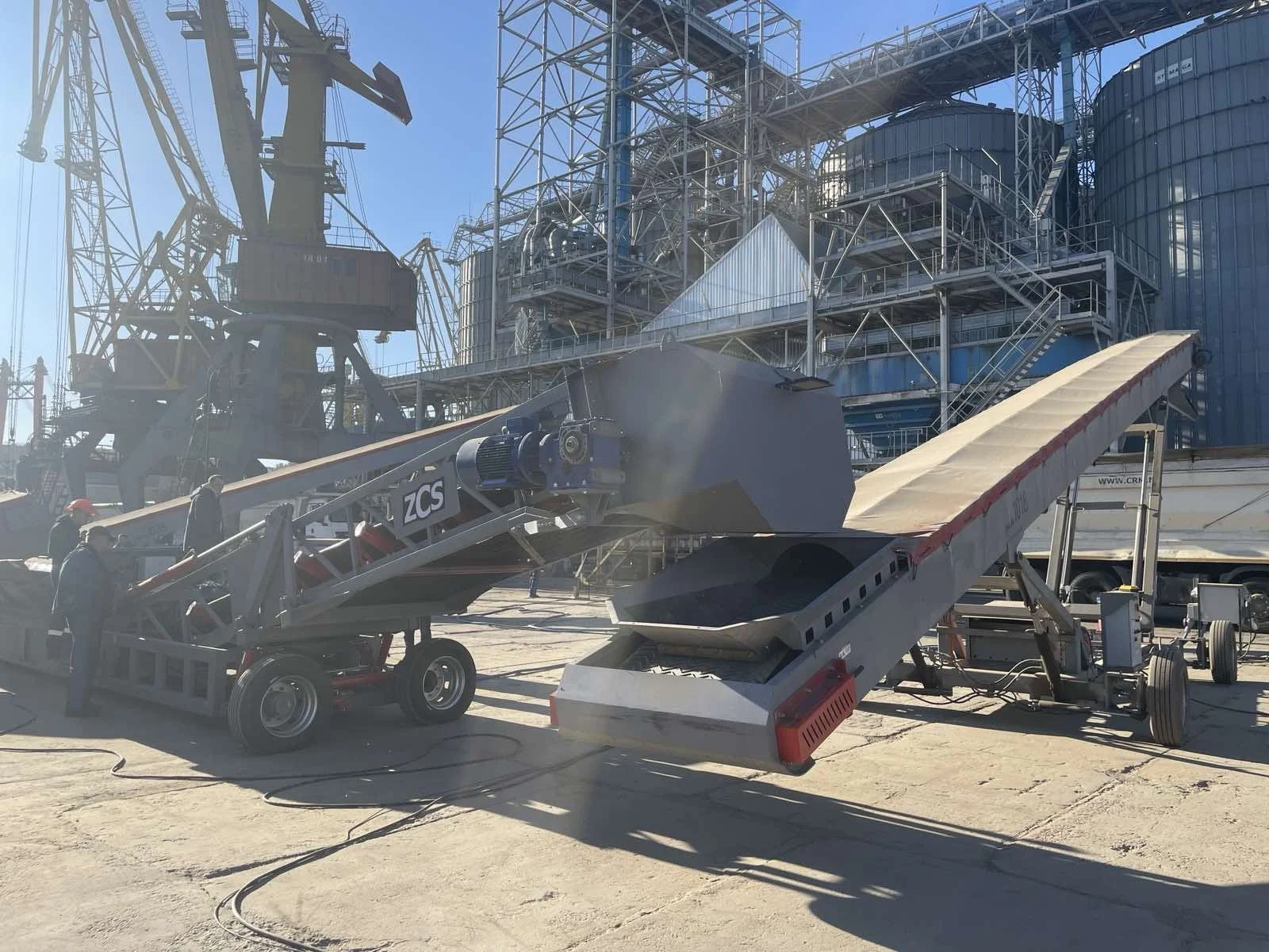 Two wheeled mobile conveyors at a grain terminal